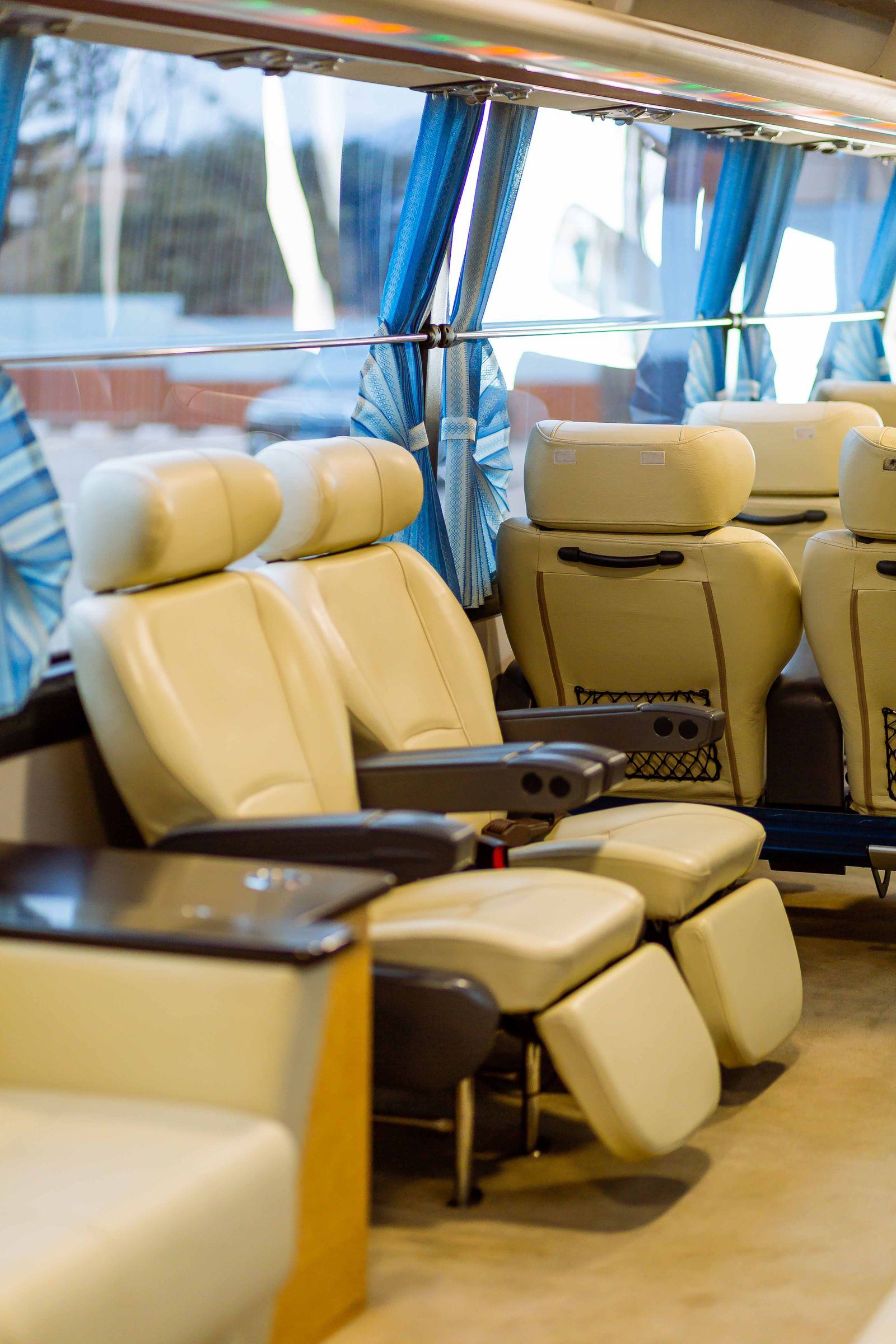 Rows of reclining seats inside a full size coach bus